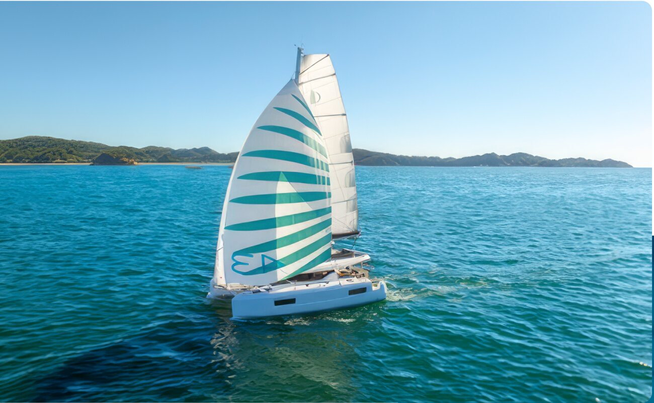Sailing catamaran cruising along the coast