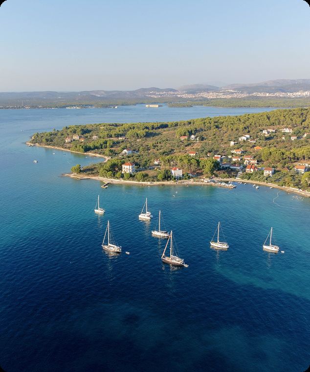 Dalmatian island with boats at anchor in a sheltered Adriatic bay