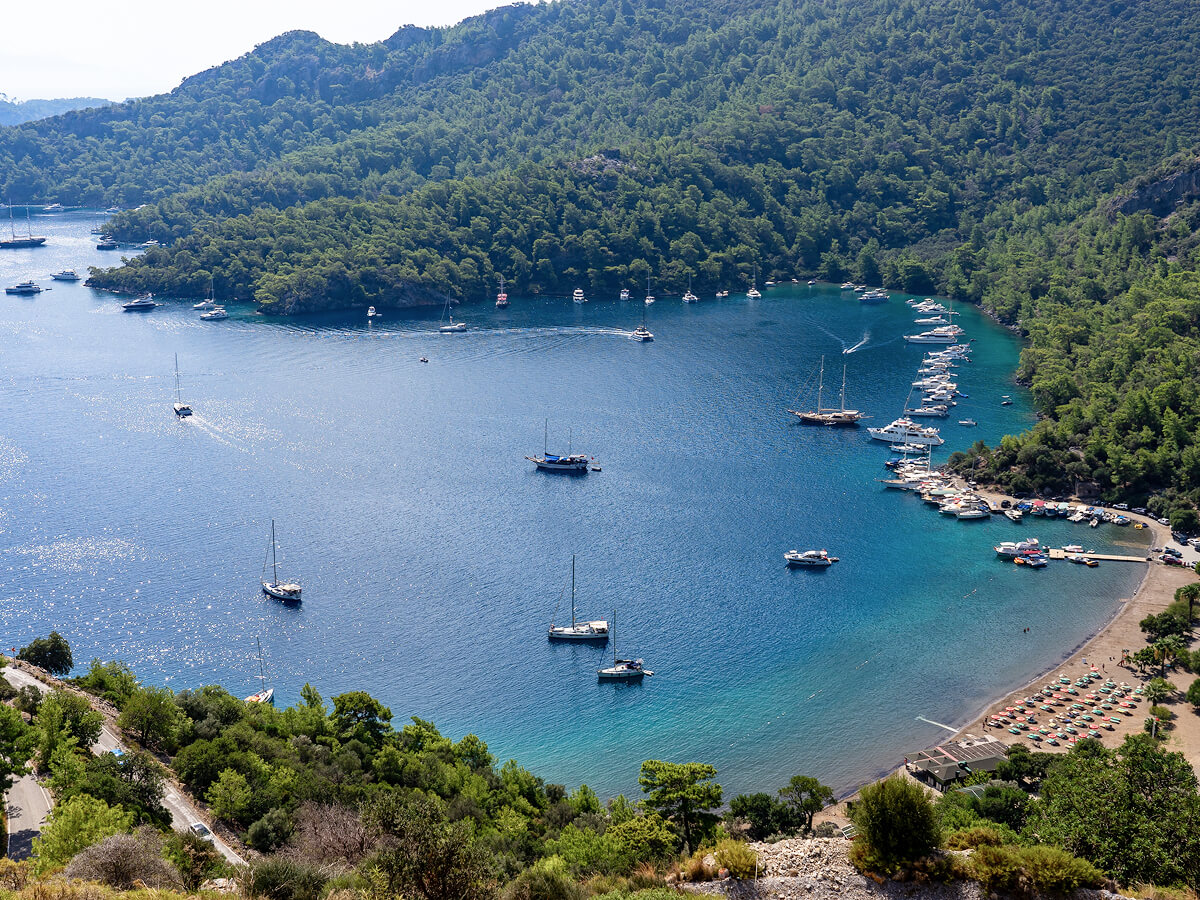 Sheltered bay on the Turkish coast with moored boats and pine-covered hills