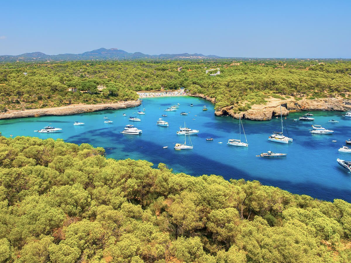 Brazilian tropical bay with green islands and boats anchored in calm water