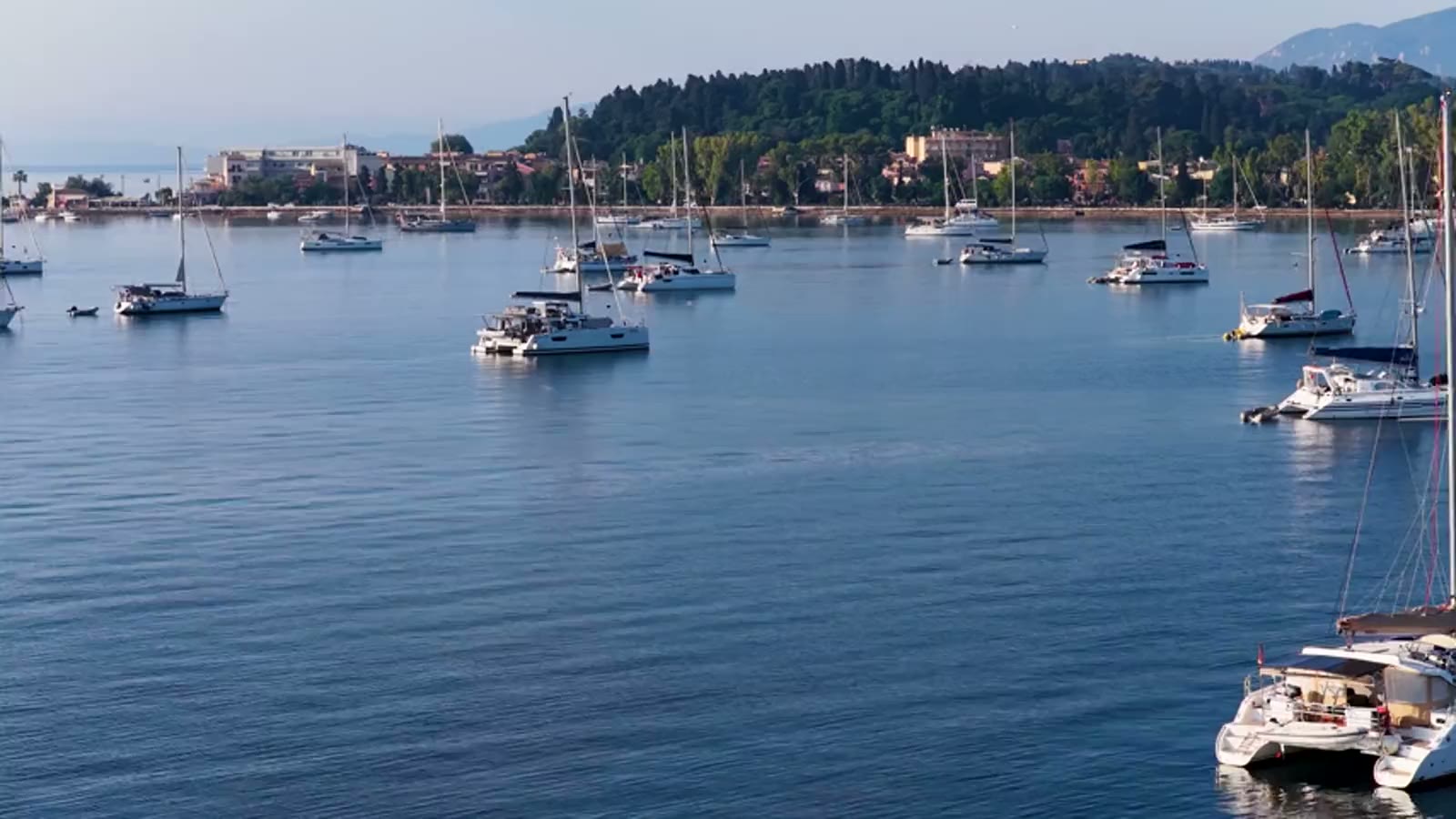 Boats moored in a bay at sunset